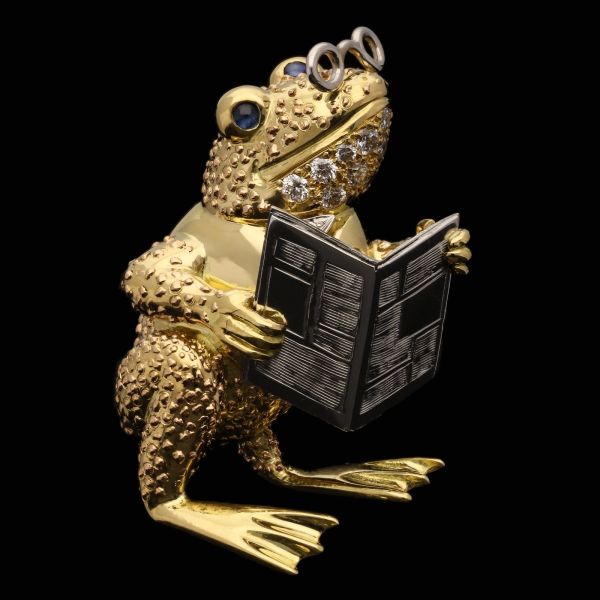 A Whimsical Gold Toad Brooch Wearing Pince-Nez And Reading The Newspaper