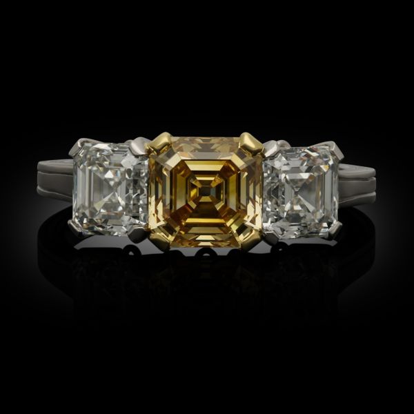 A 1.35ct Fancy Colour Asscher Cut Diamond Three Stone Ring in Platinum