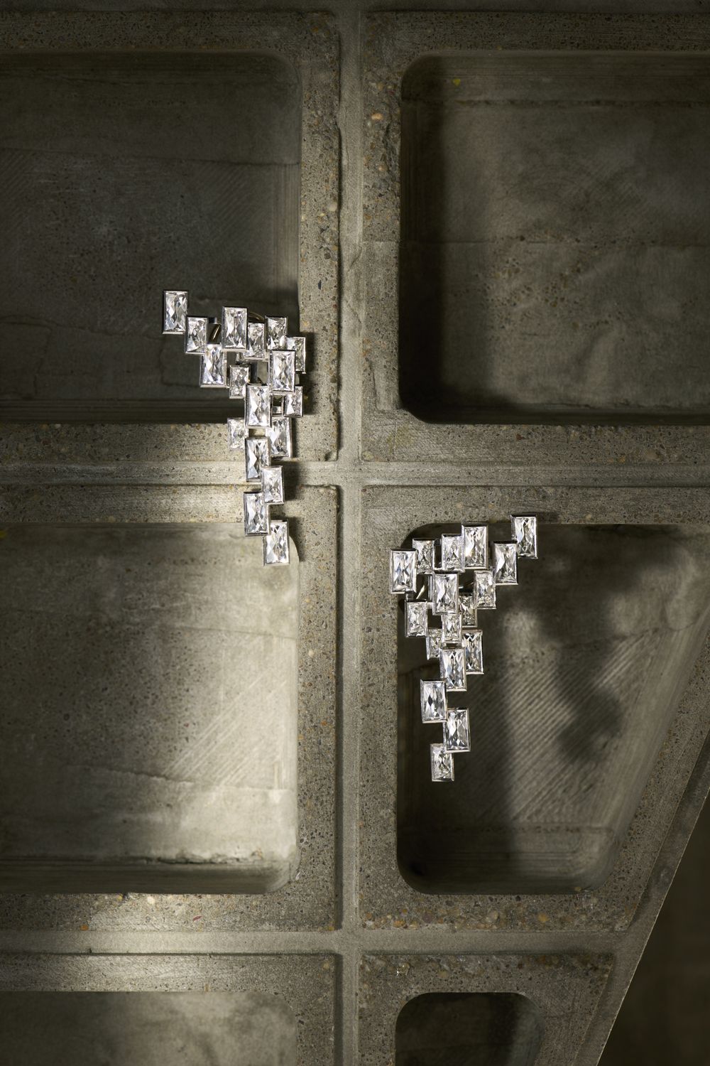 The earrings photographed on concrete